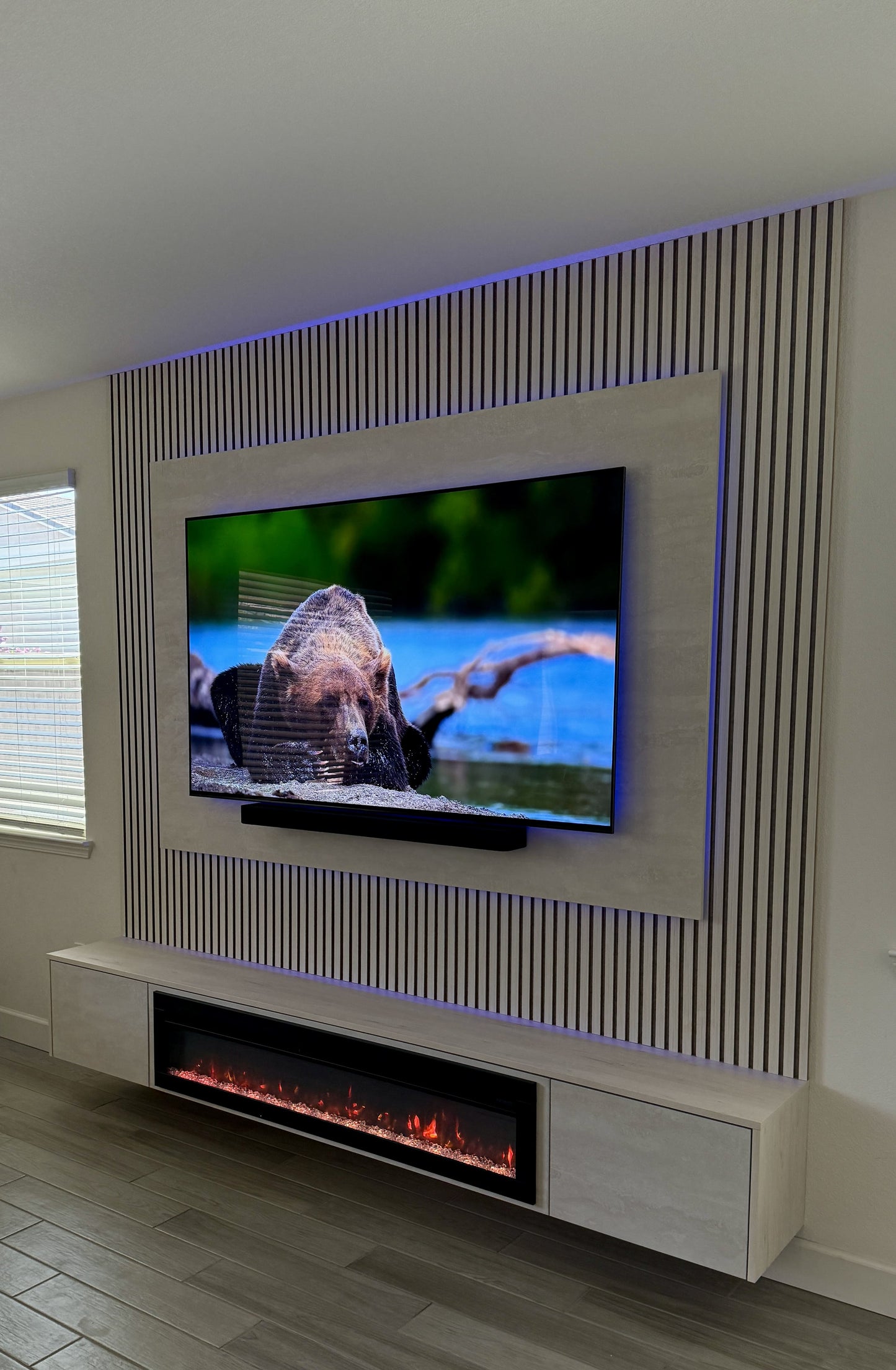 Matte black cabinetry with modern TV wall