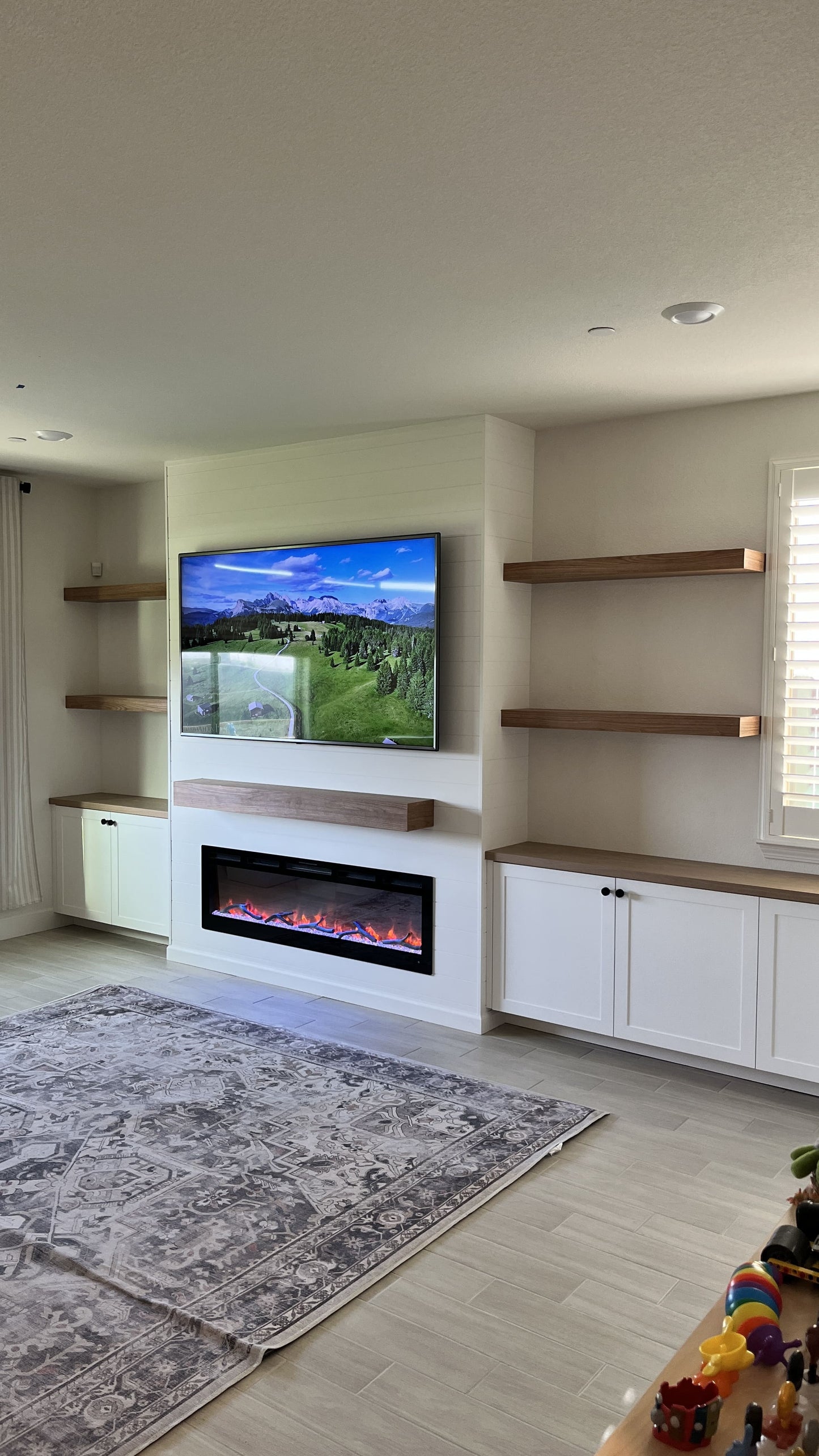 Custom media wall with fireplace and cabinetry