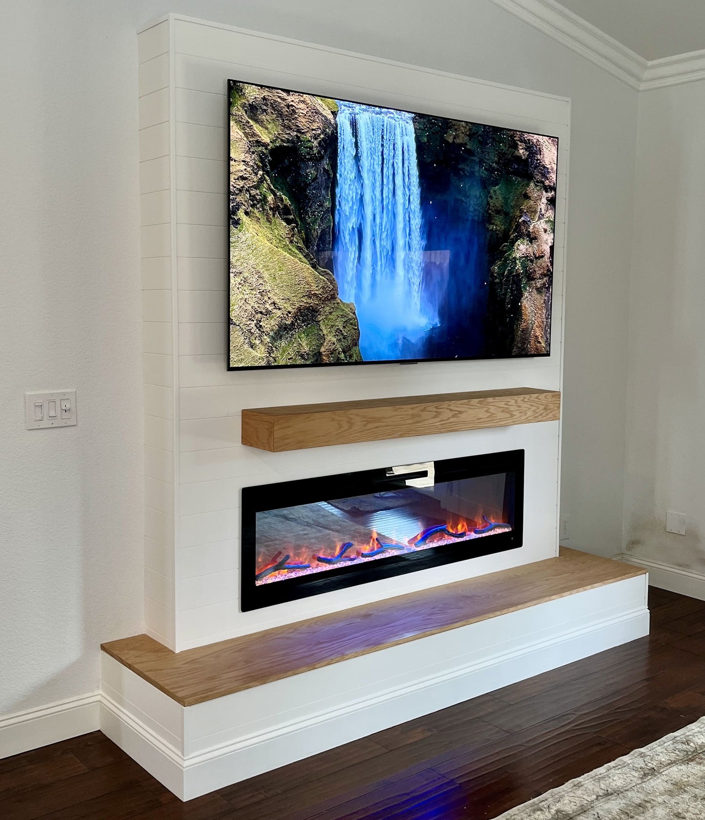 Media wall with recessed lighting creating cozy atmosphere