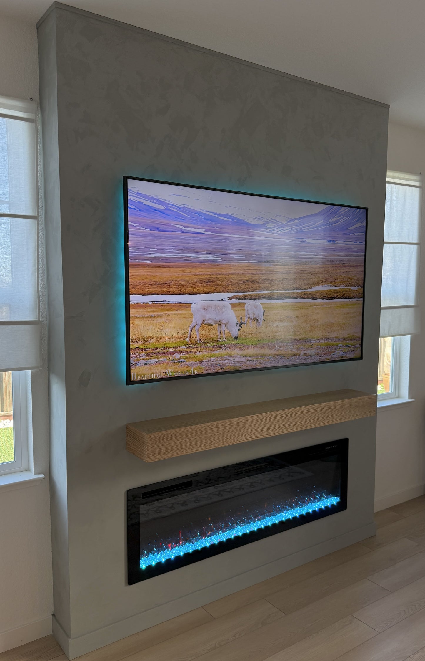 Designer media wall with TV above fireplace