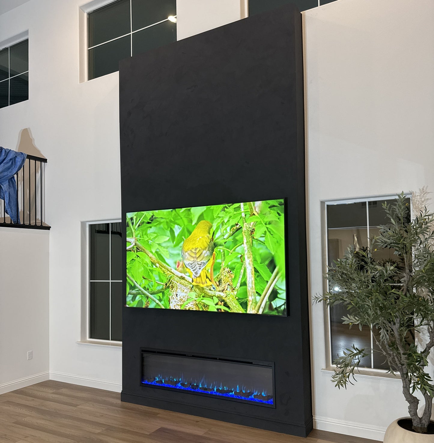 Luxury media wall combining TV and contemporary fireplace