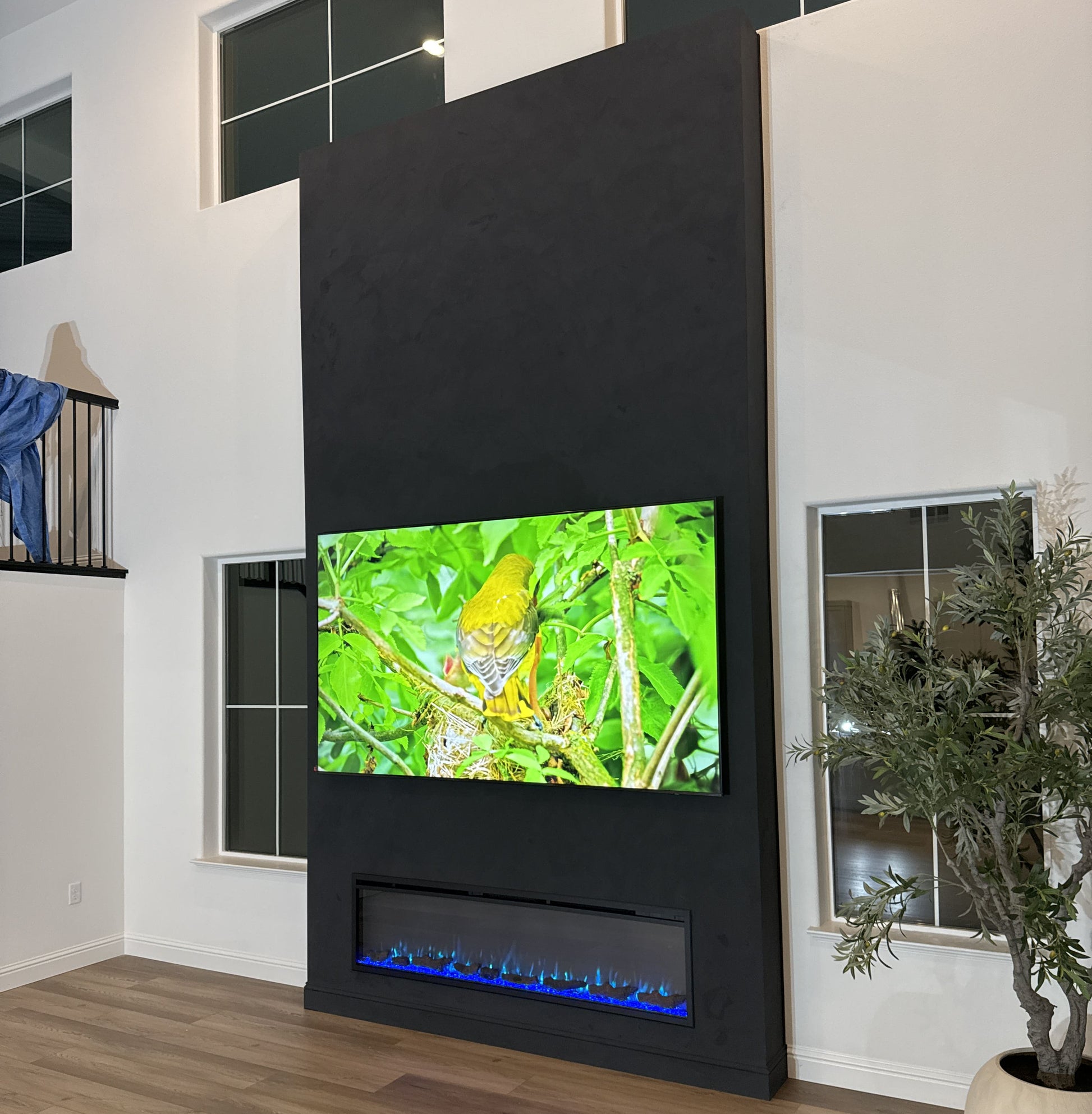 Luxury media wall combining TV and contemporary fireplace