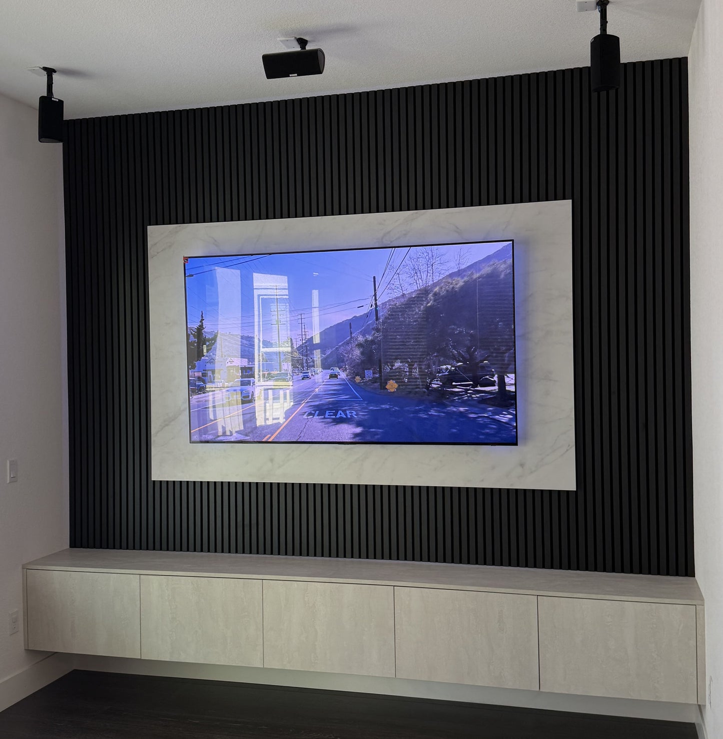Matte black cabinetry with modern TV wall