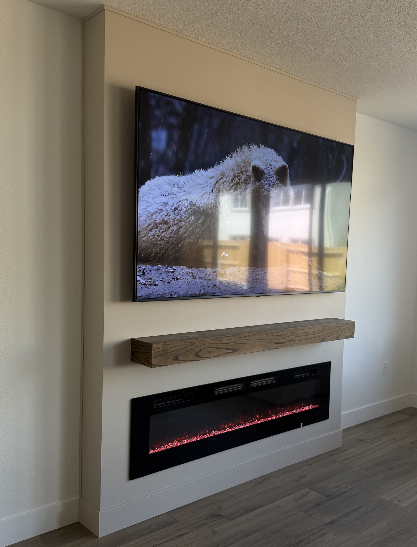 Wall-mounted flat-screen TV within custom media wall