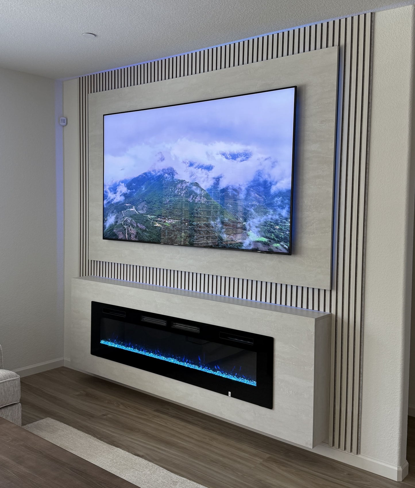 TV wall with natural wood slatted panels