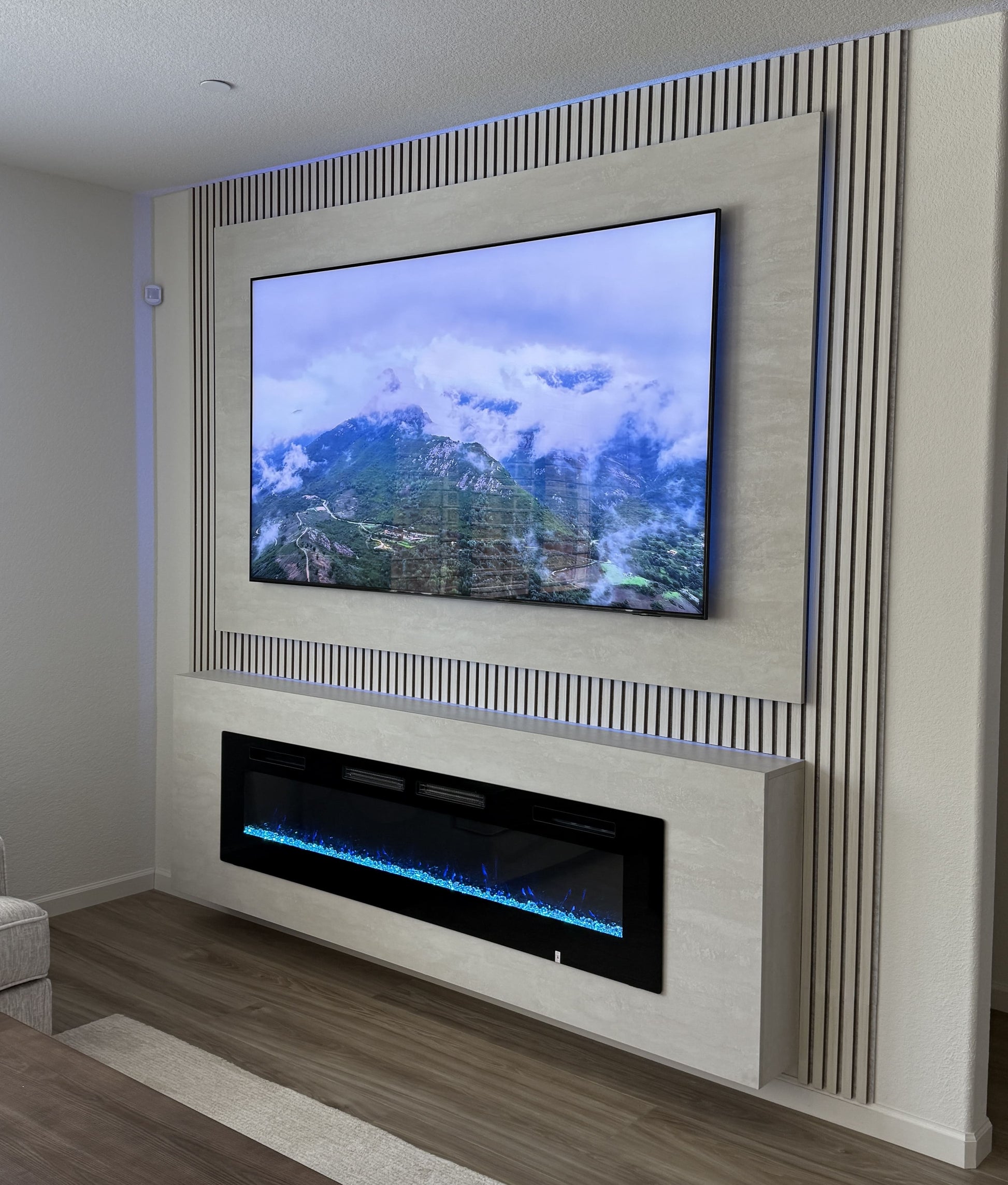 TV wall with natural wood slatted panels
