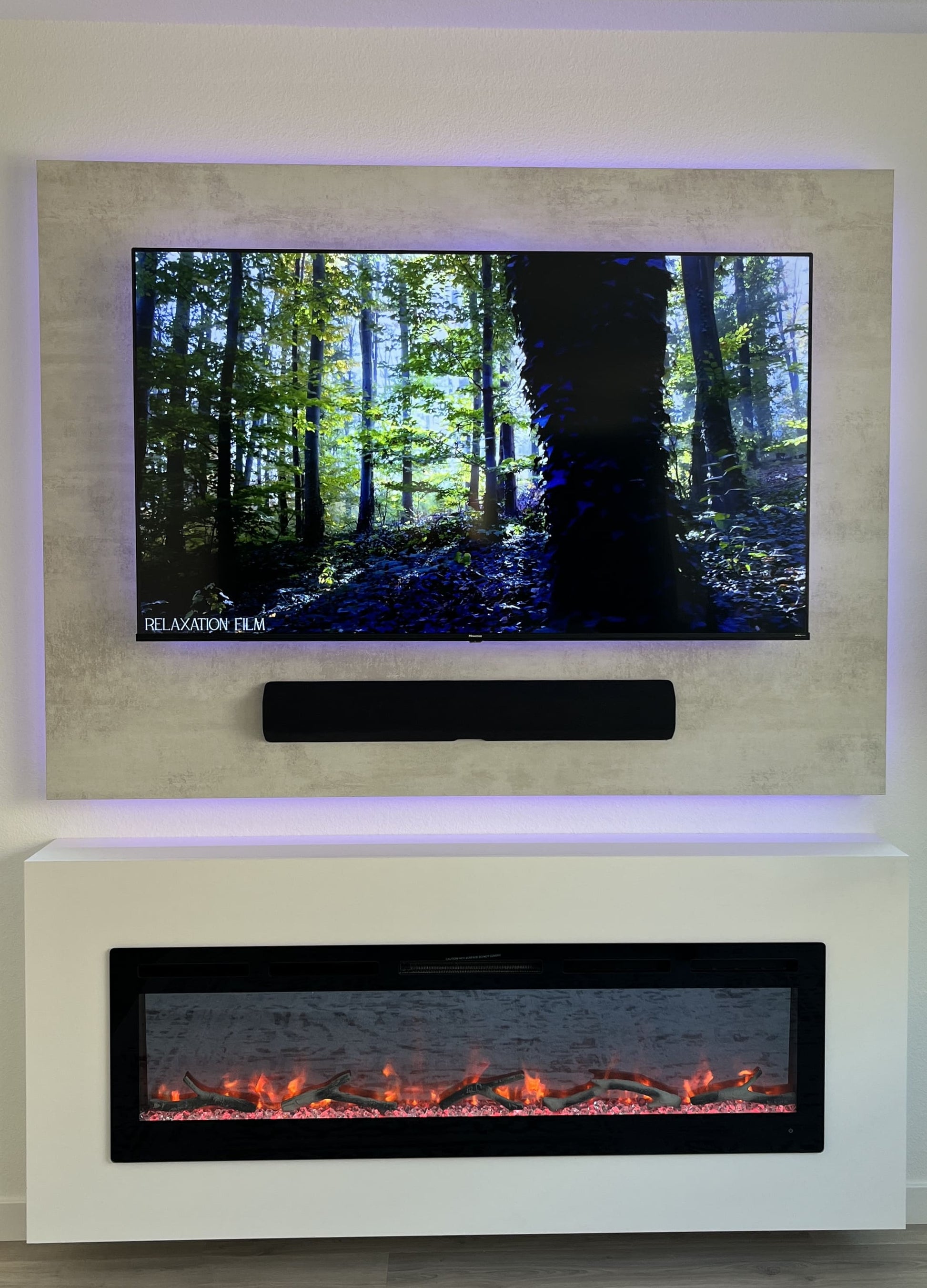 Designer media wall with TV above fireplace