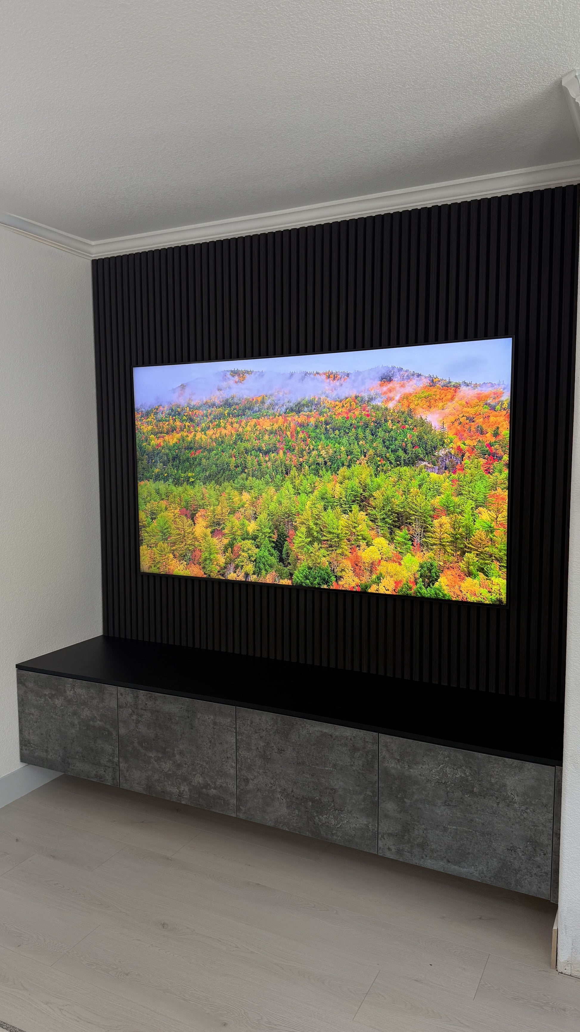 Walnut cabinetry with bespoke TV wall