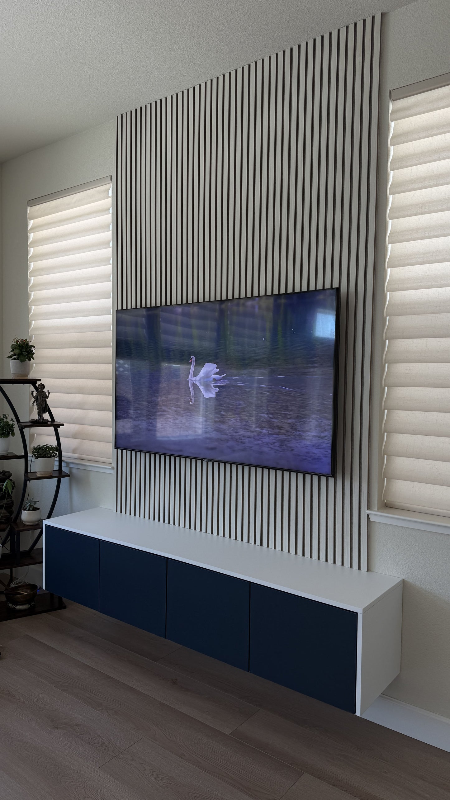 High-gloss white cabinetry with TV media wall