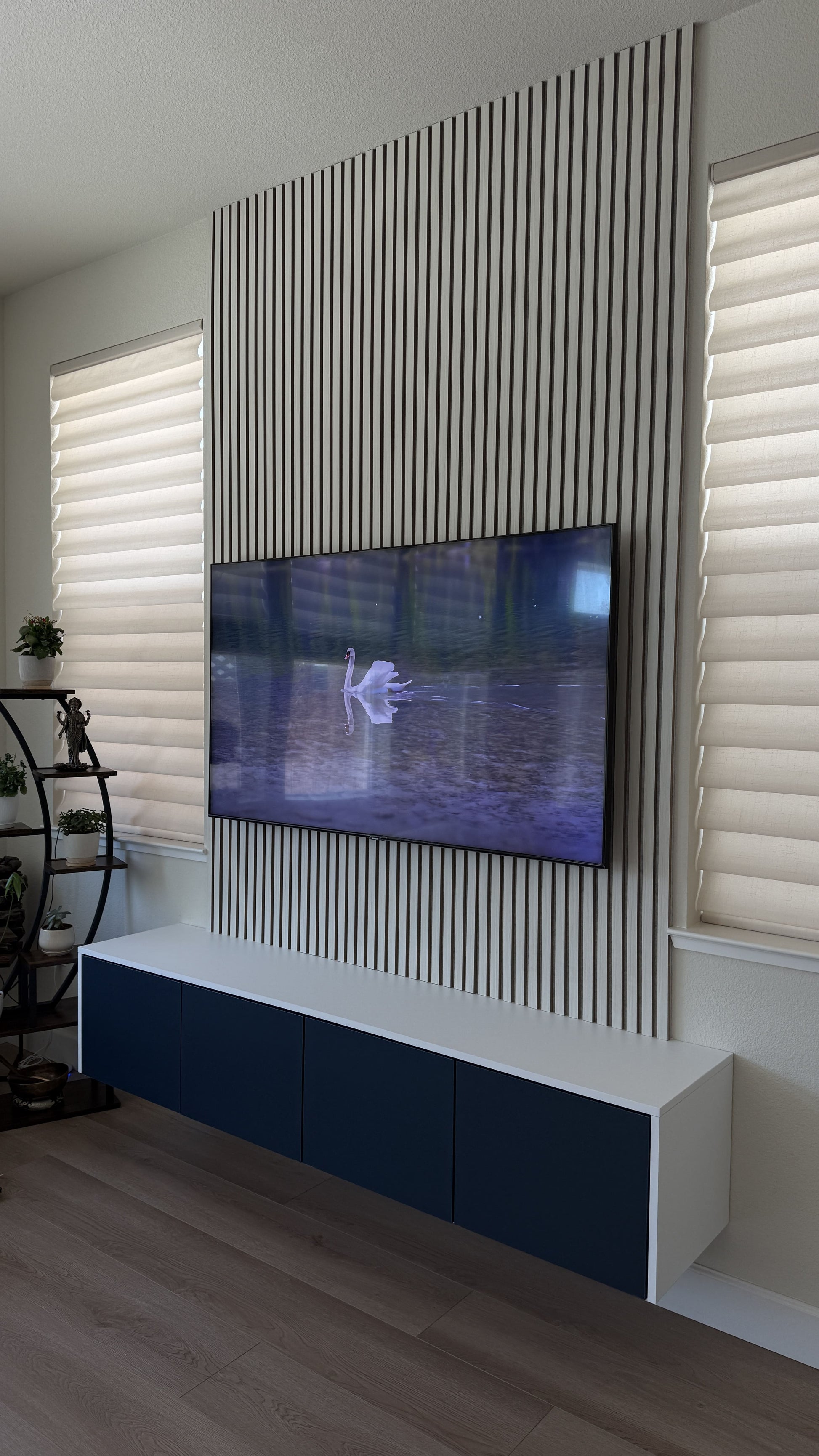 High-gloss white cabinetry with TV media wall