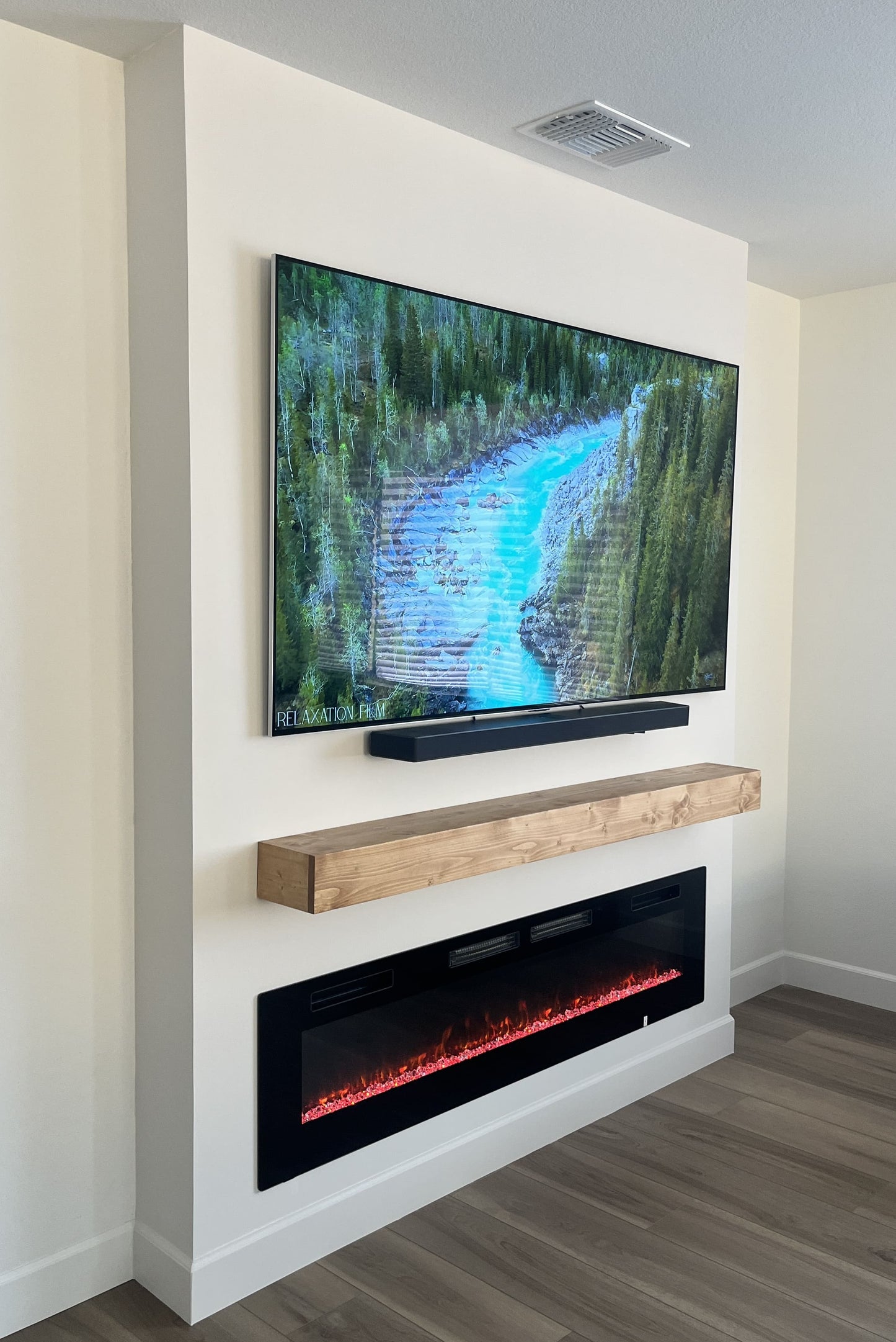 Custom media wall with integrated shelving and cabinets