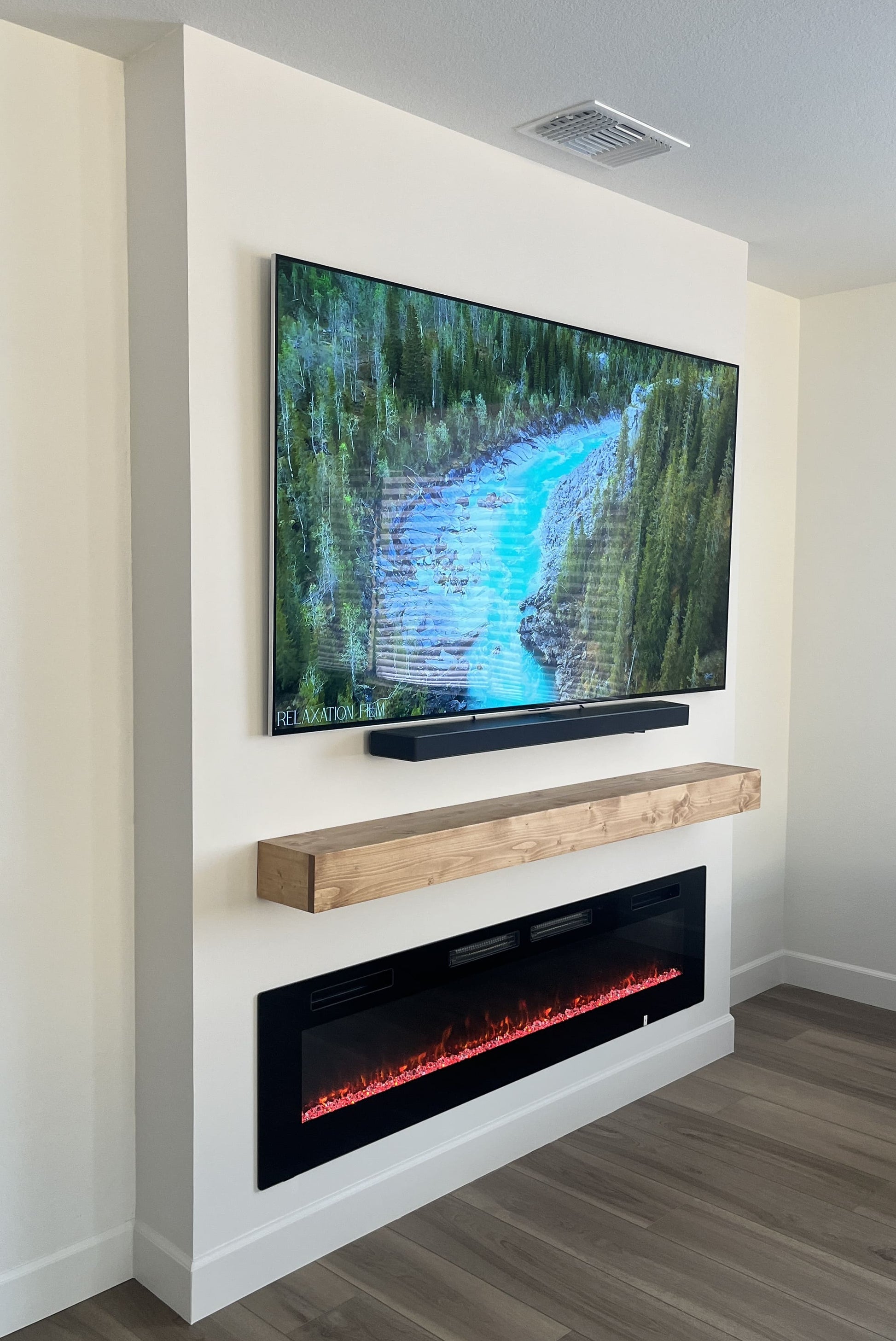 Custom media wall with integrated shelving and cabinets