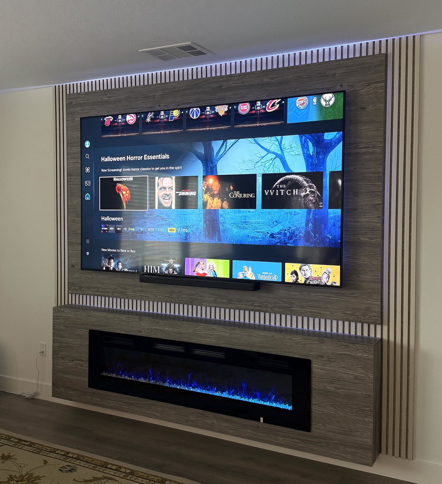 TV wall with recessed LED strip lighting
